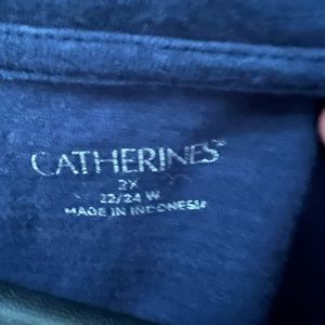 Catherine’s navy blue tunic w floral pattern.